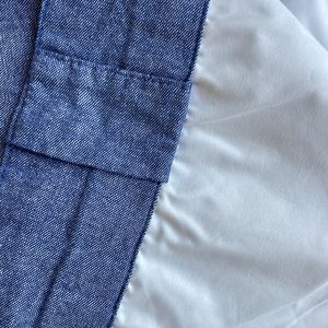 Set of two room darkening curtain panels.